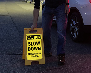 Reflective stand up slow down for pedestrians in parking lot sign