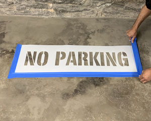 Taping around a no parking stencil