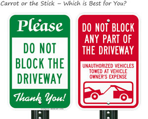 Two different strategies for do not block driveway signs