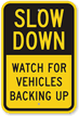 Slow Down Watch For Vehicles Backing Up Sign