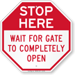 Stop Here Wait For Gate To Completely Open Sign